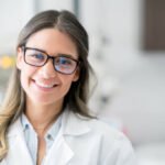 Portrait of a happy doctor at the hospital looking at the camera smiling - healthcare and medicine concepts